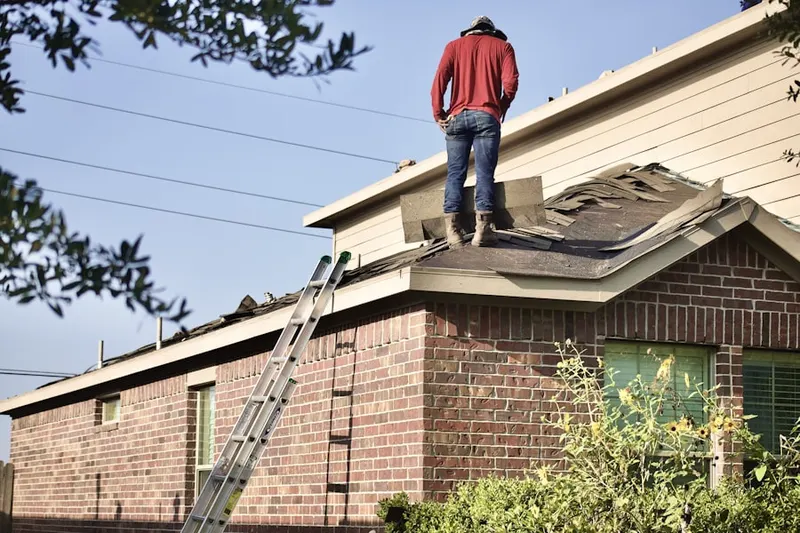 Professional roofer working on a residential roof in Delthome